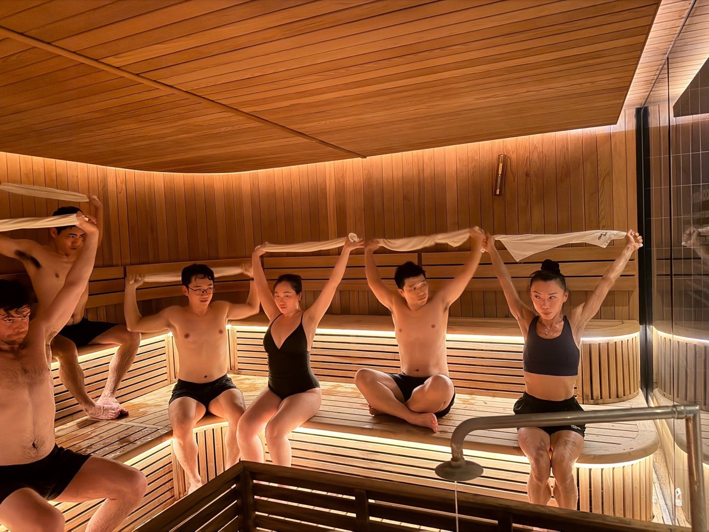 Members stretching together on the sauna benches at Duxton