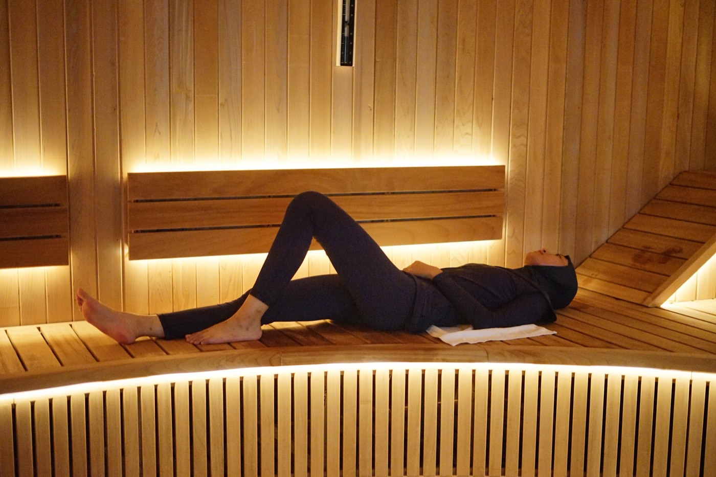 A member stretched out on the sauna bench at Gunawarman, Jakarta
