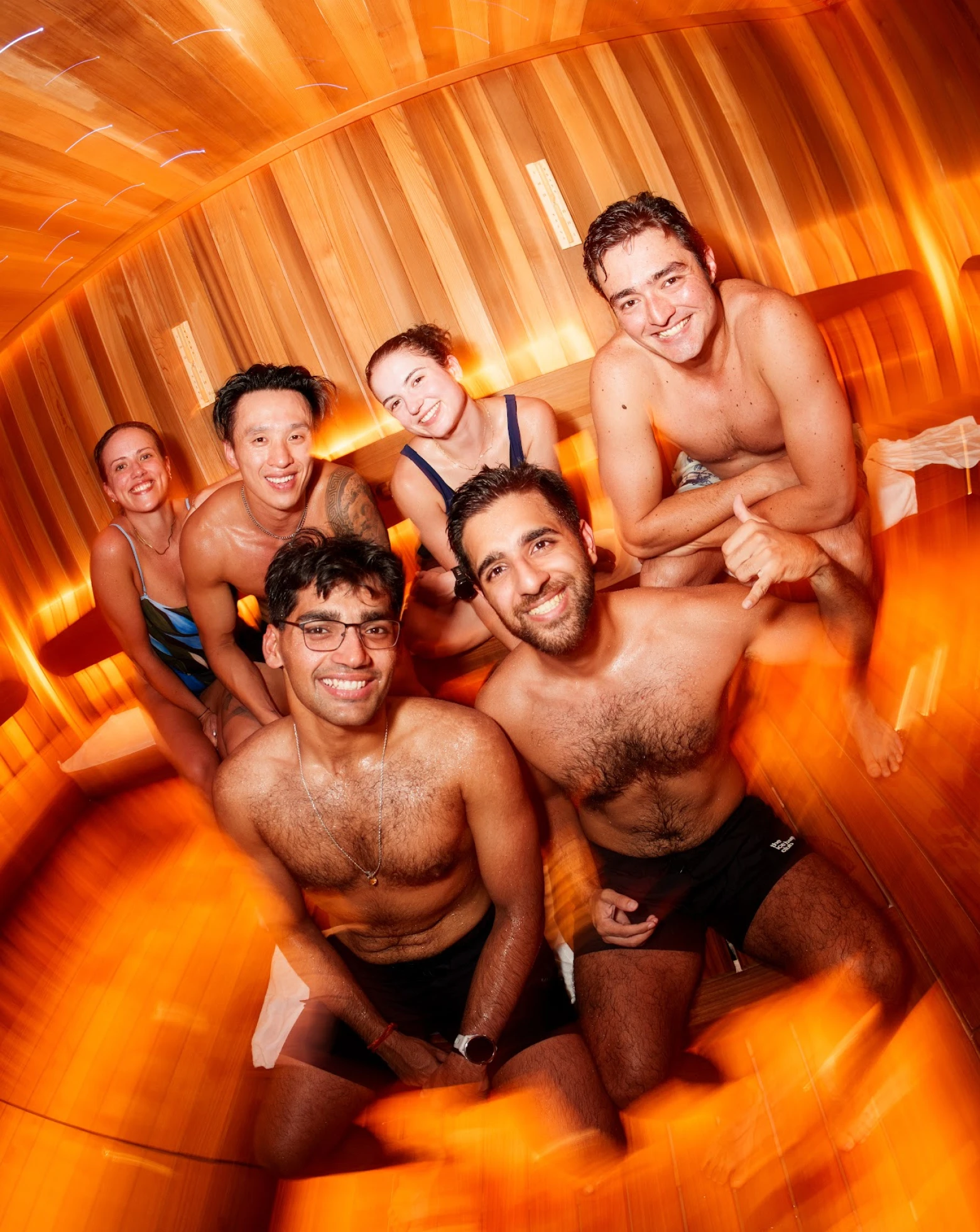 Friends smiling together in the sauna