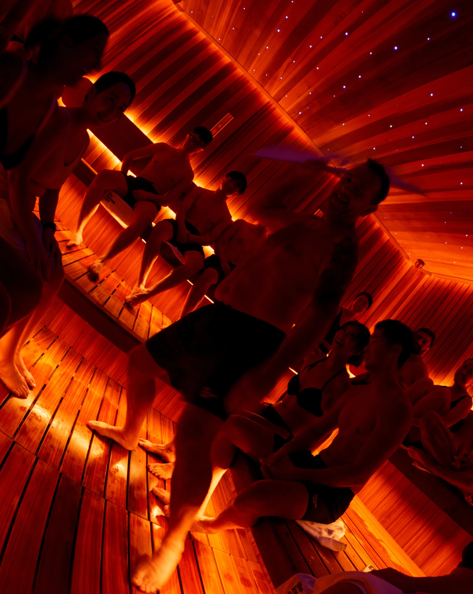 A packed sauna session under red light