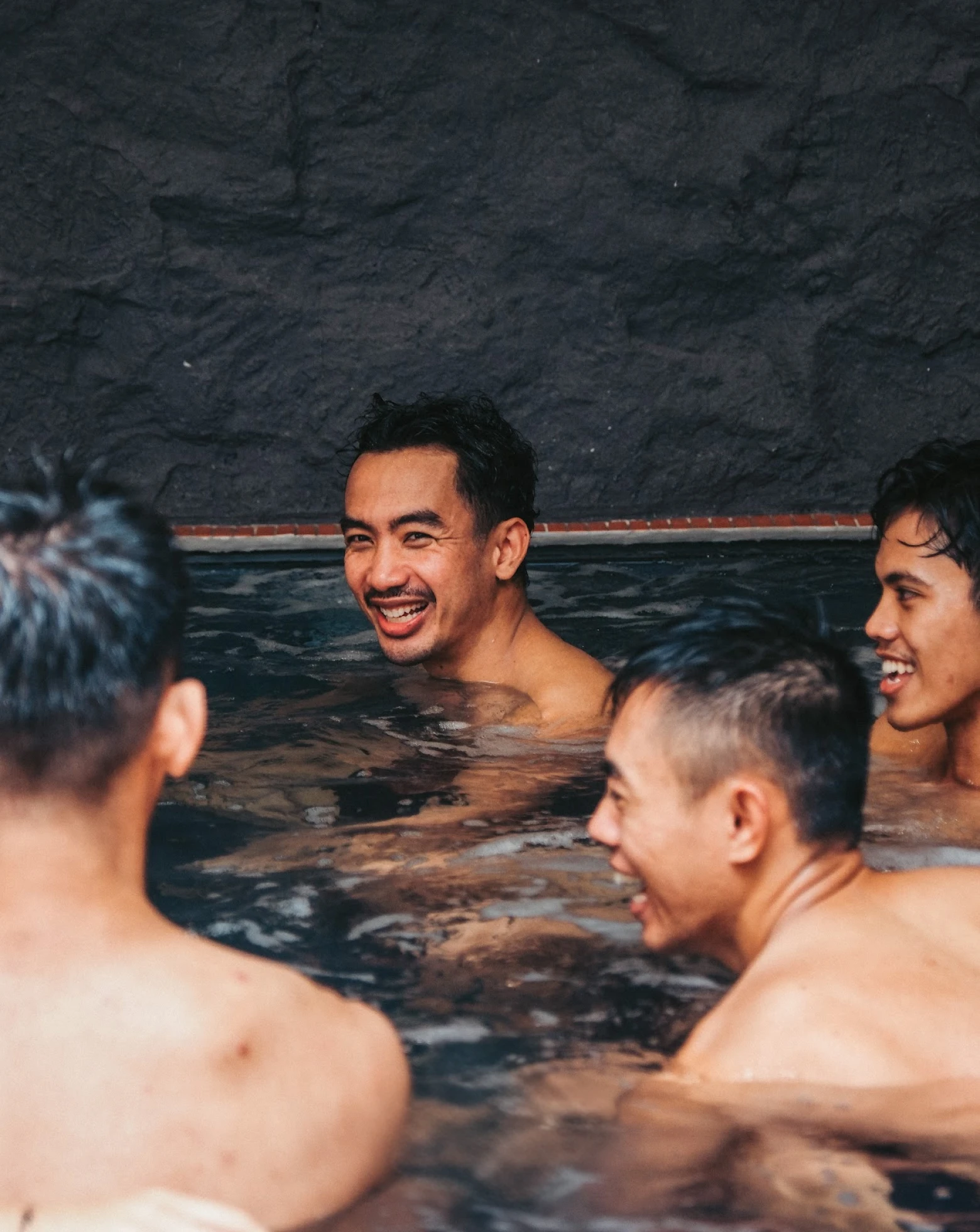 Members laughing together in the bath