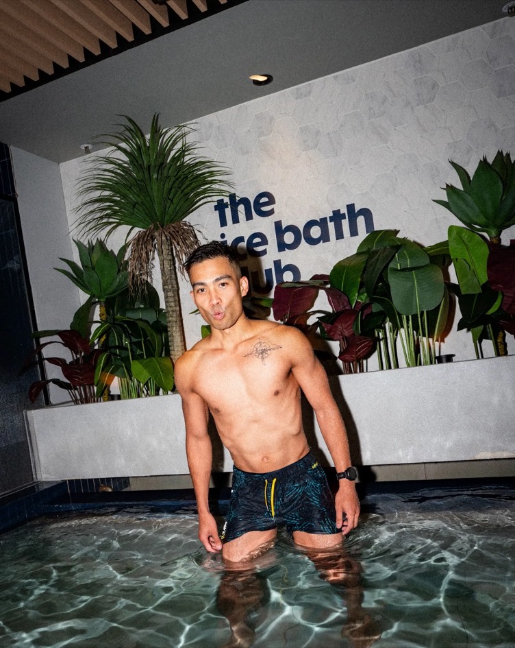 A member standing waist-deep in the ice bath