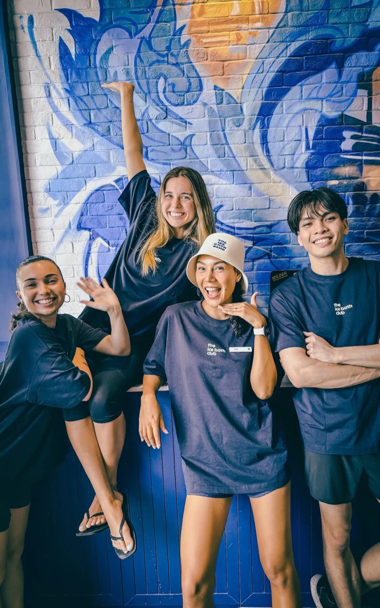 Four of the team in front of the Bangkok mural