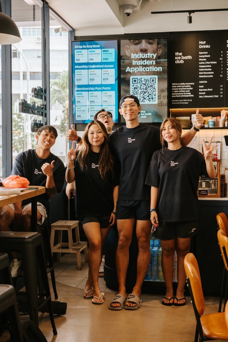 The team in the café, thumbs up