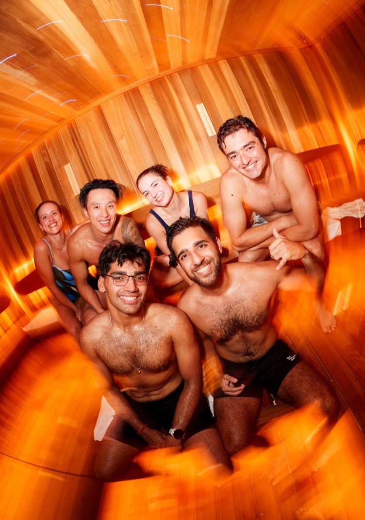 Six friends smiling in the sauna