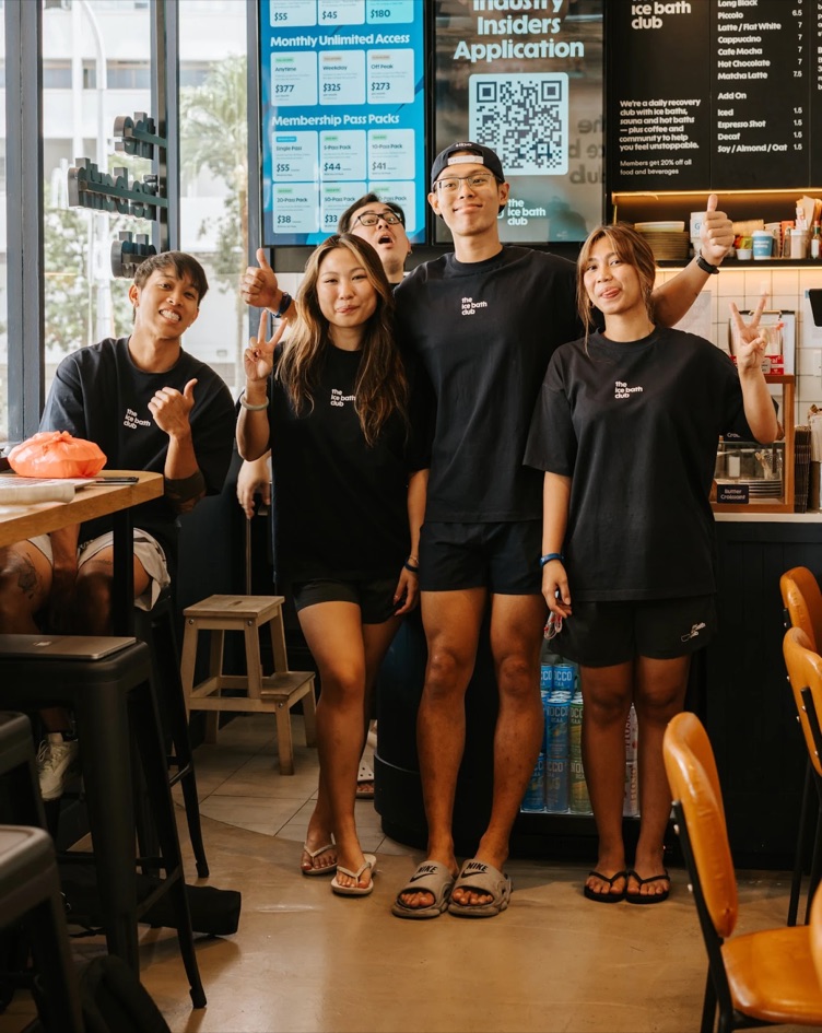 The team behind the coffee bar, thumbs up
