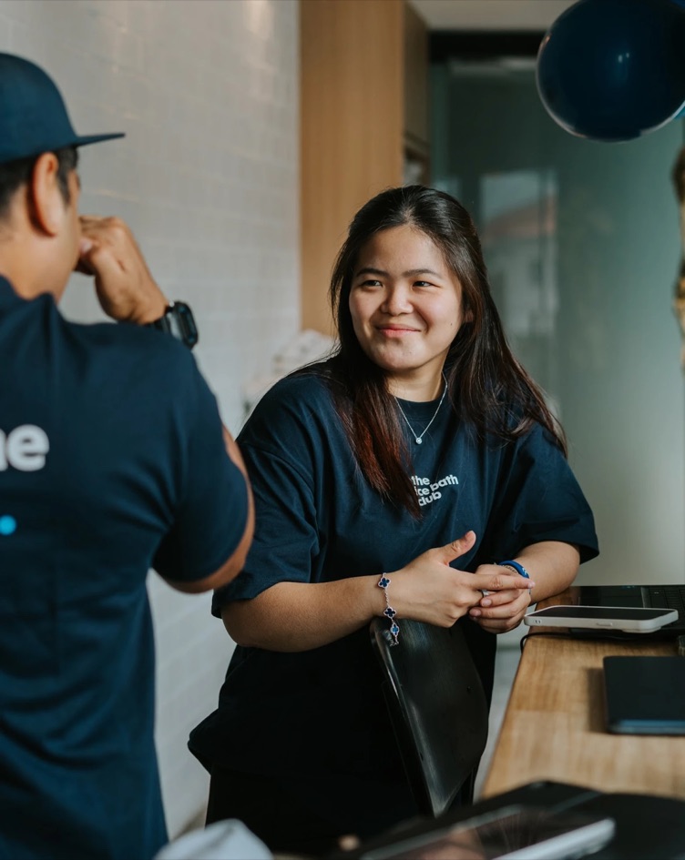 One of the team smiling at the front desk
